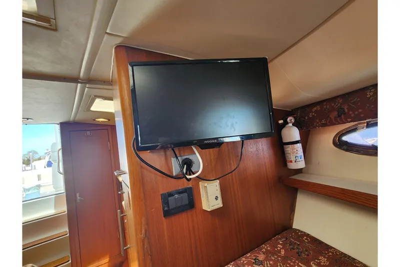 Slide: The Image of 2003 Tiara Yachts 3100 Open LE interior with TV and fire extinguisher. - 33