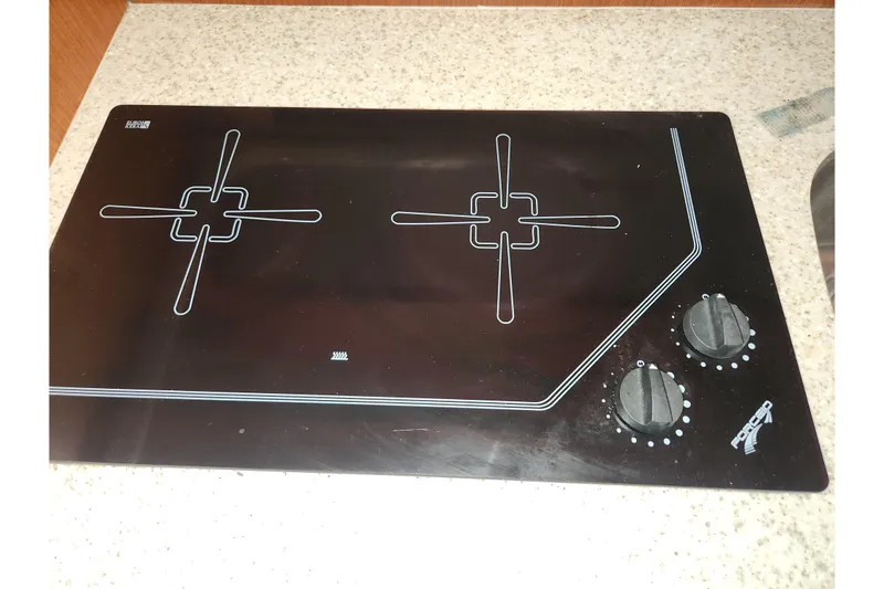 Slide: The Image of Black glass cooktop with two burners and control knobs on a Tiara Yachts 3100 Open LE. - 36