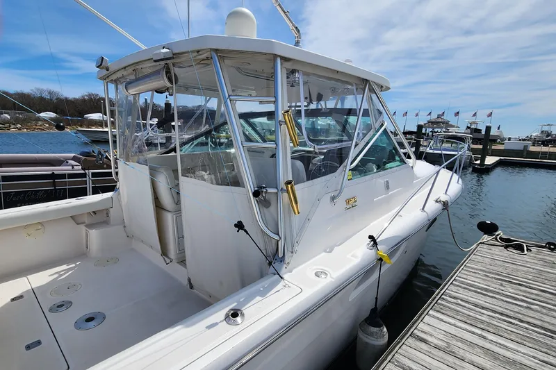 Slide: The Image of 2003 Tiara Yachts 3100 Open LE docked at marina under clear sky. - 4