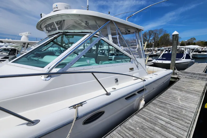 Slide: The Image of 2003 Tiara Yachts 3100 Open LE docked at marina under clear blue sky. - 40