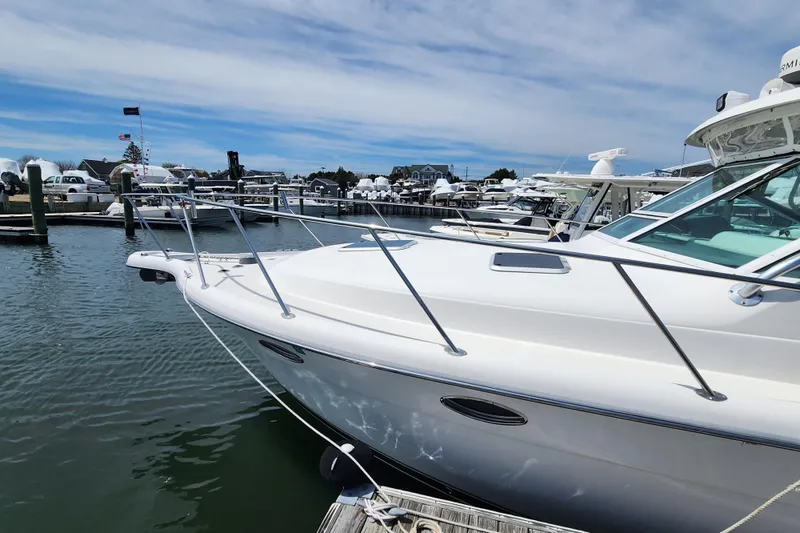 Slide: The Image of 2003 Tiara Yachts 3100 Open LE docked at a marina under a clear sky. - 41