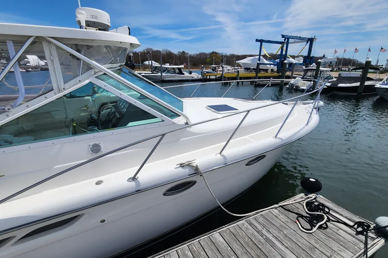 Slide: The Image of 2003 Tiara Yachts 3100 Open LE docked at a marina under a clear blue sky. - 42