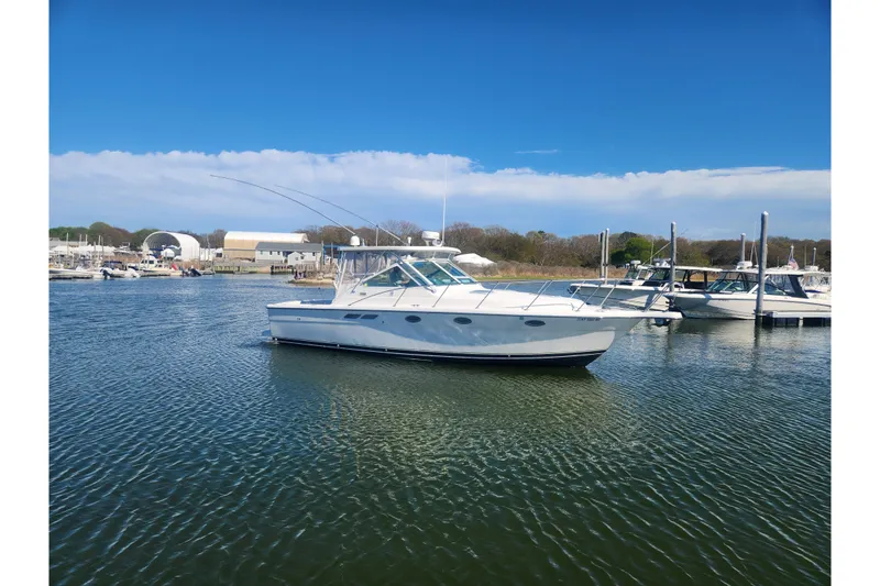 Slide: The Image of 2003 Tiara Yachts 3100 Open LE in a serene marina setting. - 51