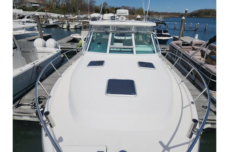Slide: The Image of 2003 Tiara Yachts 3100 Open LE docked at marina, showcasing sleek design and spacious deck. - 53