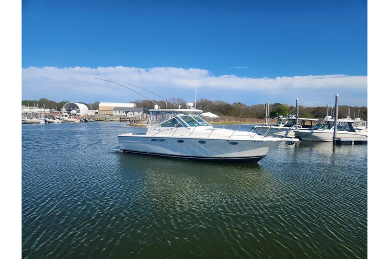 Slide: The Image of 2003 Tiara Yachts 3100 Open LE in a serene marina setting. - 56