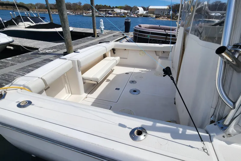 Slide: The Image of 2003 Tiara Yachts 3100 Open LE boat interior at dock, featuring spacious seating area. - 6