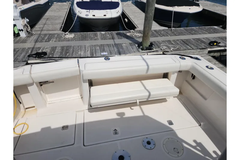 Slide: The Image of 2003 Tiara Yachts 3100 Open LE cockpit with seating and dock view. - 7