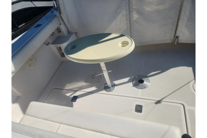 Slide: The Image of 2003 Tiara Yachts 3100 Open LE interior with round table and seating area. - 8