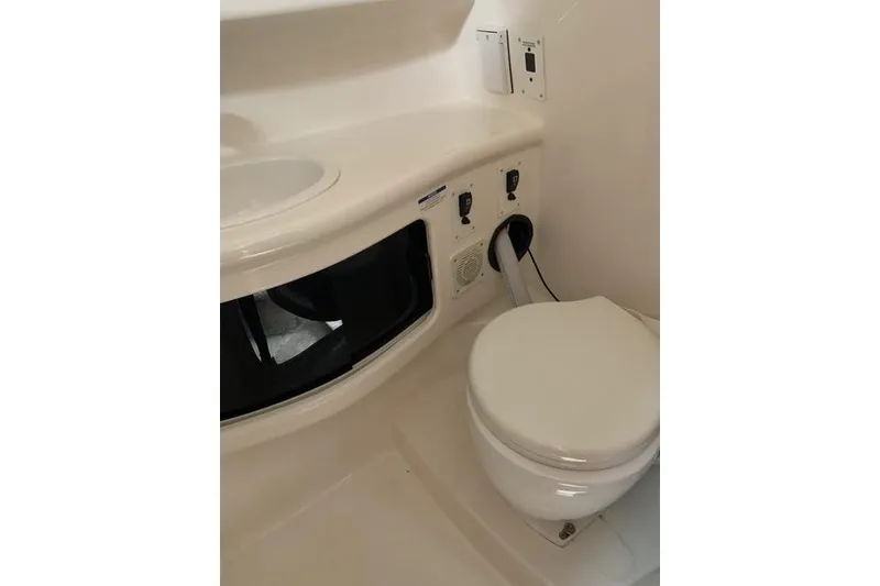 Slide: The Image of 2002 Chaparral Signature 260 boat bathroom with toilet and sink. - 11