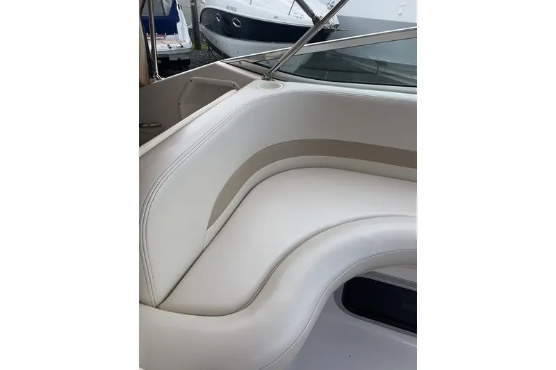 Slide: The Image of 2002 Chaparral Signature 260 boat interior with white cushioned seating. - 12