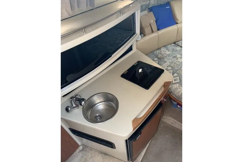 Slide: The Image of 2002 Chaparral Signature 260 interior kitchenette with sink and stove. - 14