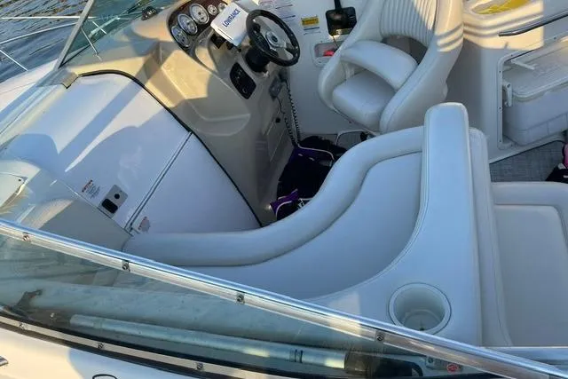 Slide: The Image of 2002 Chaparral Signature 260 boat interior with white seating and control panel. - 16