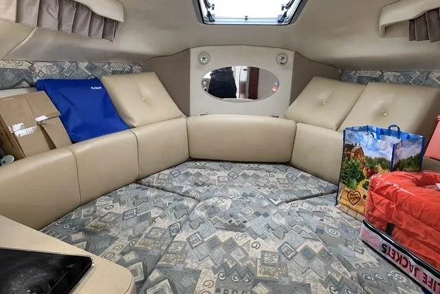 Slide: The Image of Interior of a 2002 Chaparral Signature 260 boat with beige seating and patterned cushions. - 17