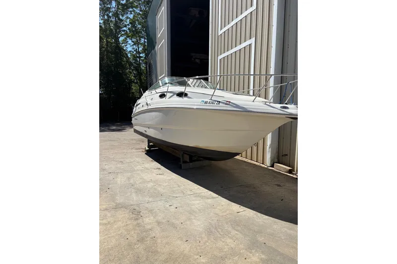 Slide: The Image of 2002 Chaparral Signature 260 boat docked outside a storage facility. - 3