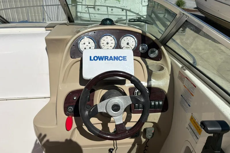 Slide: The Image of 2002 Chaparral Signature 260 boat dashboard with Lowrance navigation system and gauges. - 8