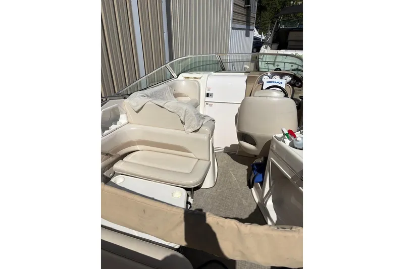 Slide: The Image of 2002 Chaparral Signature 260 boat interior with beige seating and steering console. - 9