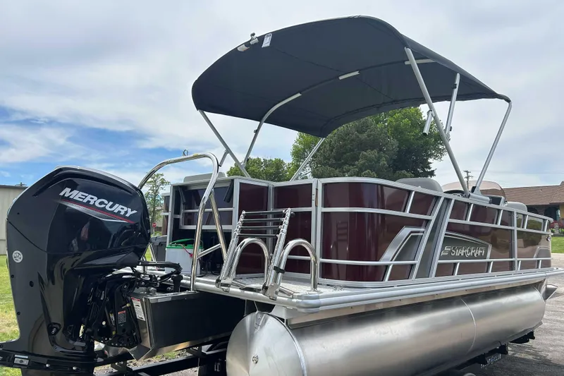 Slide: The Image of 2026 Starcraft EX 20 F pontoon boat with Mercury outboard motor and canopy. - 10
