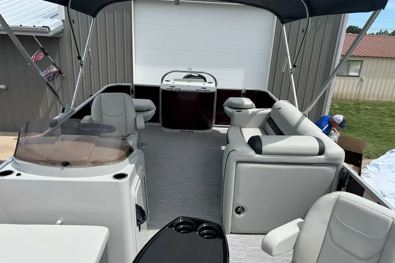 Slide: The Image of 2026 Starcraft EX 20 F pontoon boat interior with seating and helm under canopy. - 7