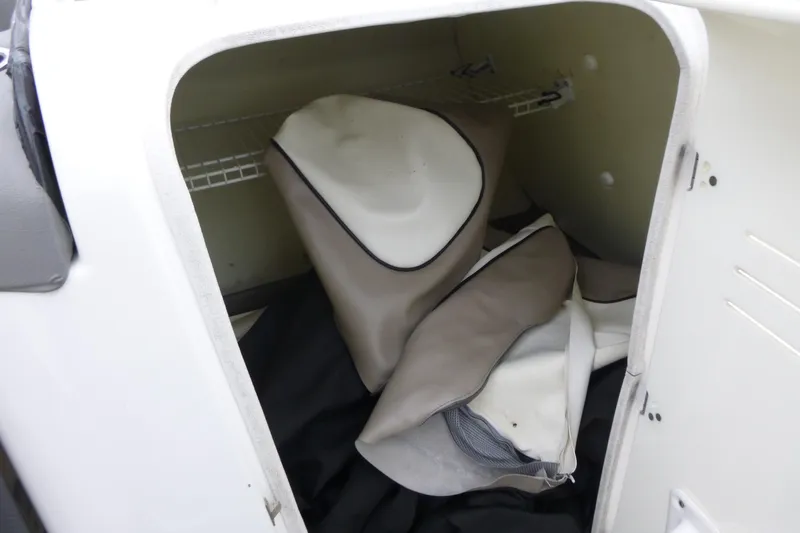 Slide: The Image of Storage compartment of 2011 Yamaha Boats 242 Limited S with cushions and covers. - 10