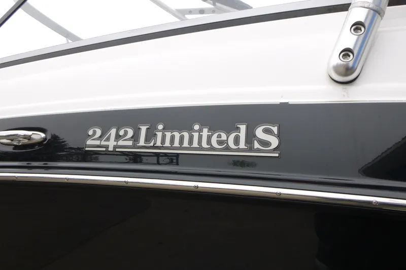 Slide: The Image of 2011 Yamaha Boats 242 Limited S logo on sleek black and white hull. - 3