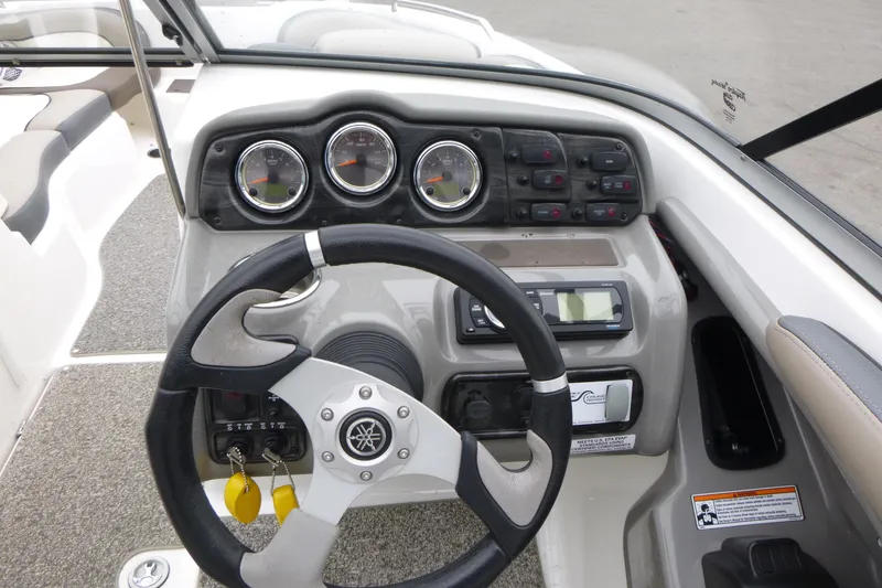 Slide: The Image of Steering console of 2011 Yamaha Boats 242 Limited S with gauges and controls. - 7