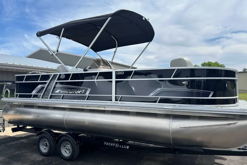 Slide: The Image of 2026 Starcraft EX 22 FD pontoon boat with canopy on trailer, parked outdoors. - 11