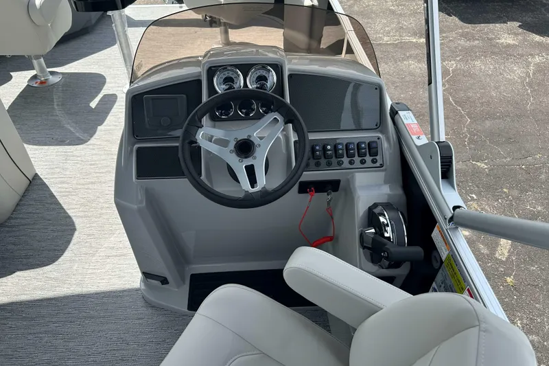 Slide: The Image of 2026 Starcraft EX 22 FD boat helm with steering wheel and control panel. - 5