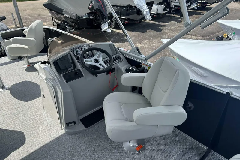 Slide: The Image of 2026 Starcraft EX 22 FD boat interior with steering console and comfortable seating. - 6