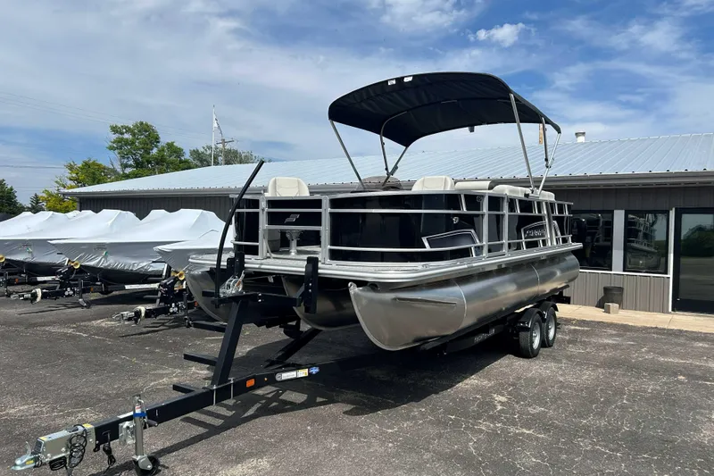 Slide: The Image of 2026 Starcraft EX 22 FD pontoon boat on trailer, parked outside dealership. - 9