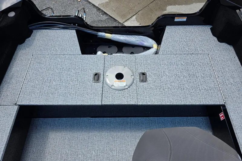 Slide: The Image of 2026 Smoker Craft Pro Angler 165 SC boat interior with gray carpeted deck. - 20