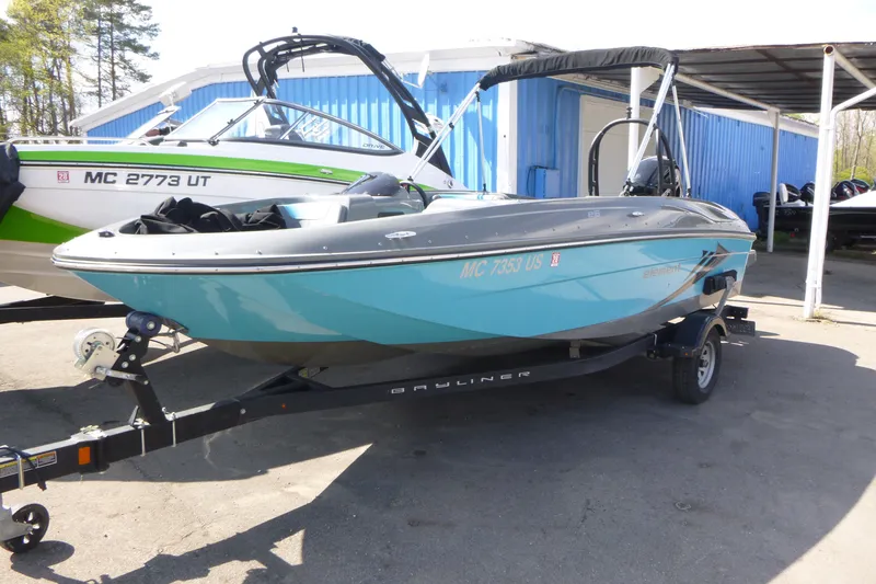 Slide: The Image of 2022 Bayliner Element E18 boat on trailer, parked outdoors. - 3