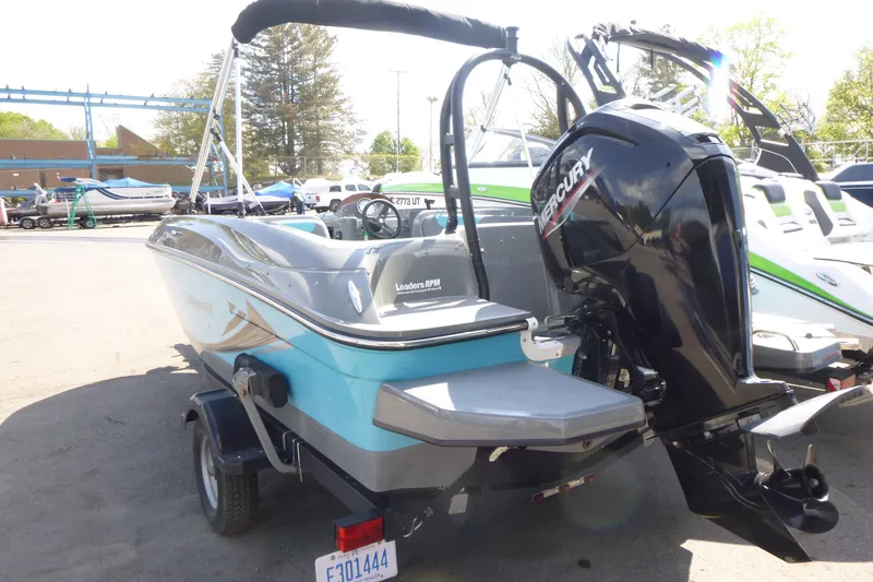Slide: The Image of 2022 Bayliner Element E18 boat with Mercury outboard motor, parked outdoors. - 4