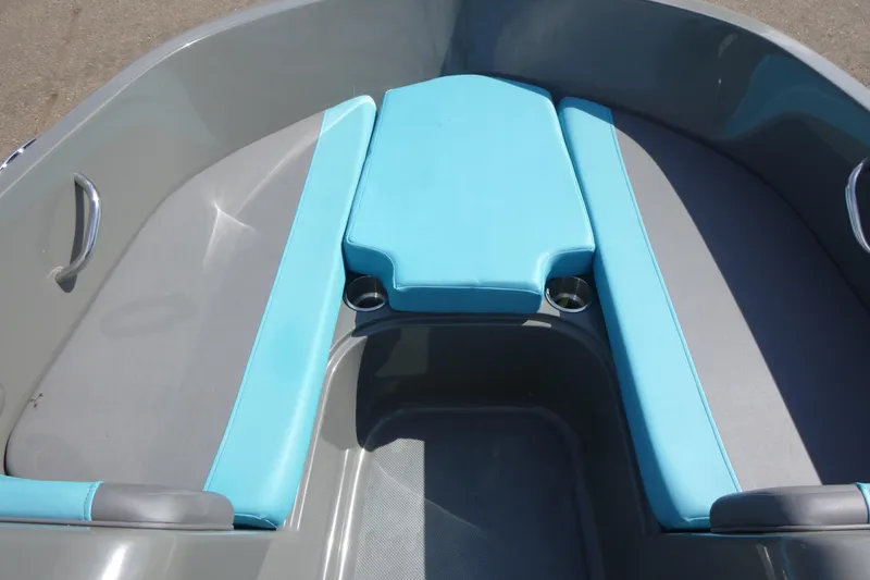 Slide: The Image of 2022 Bayliner Element E18 boat interior with blue seating and cup holders. - 6