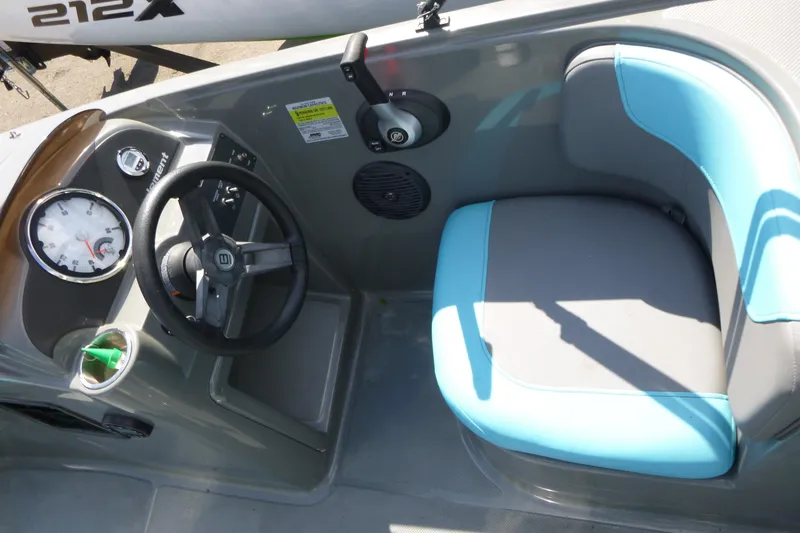 Slide: The Image of 2022 Bayliner Element E18 boat cockpit with steering wheel and blue-gray seating. - 7