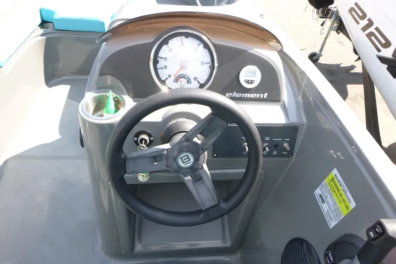 Slide: The Image of 2022 Bayliner Element E18 boat dashboard with steering wheel and instrument panel. - 8