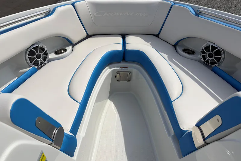 Slide: The Image of Interior of 2025 Crownline 220 SS boat with blue and white seating and speakers. - 11