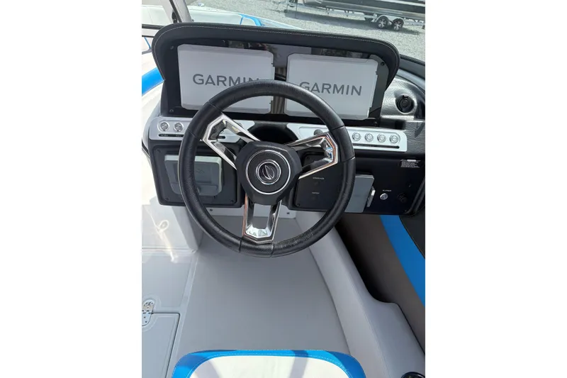Slide: The Image of 2025 Crownline 220 SS boat dashboard with Garmin navigation system and sleek steering wheel. - 13