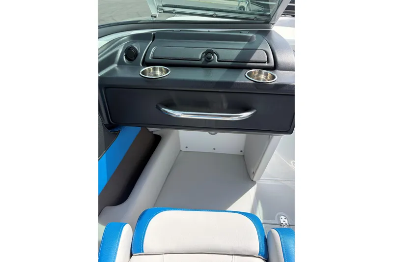 Slide: The Image of 2025 Crownline 220 SS boat interior with blue and white seating and dashboard details. - 15