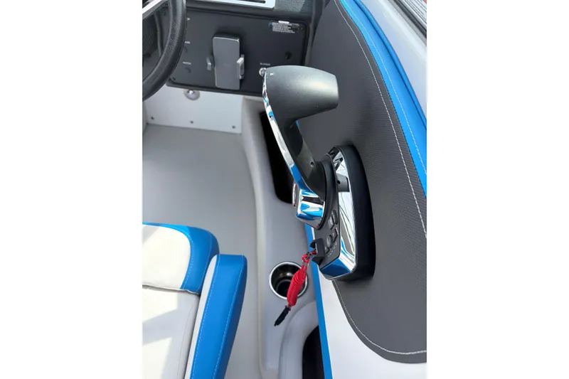 Slide: The Image of Throttle control of 2025 Crownline 220 SS boat, featuring sleek design and blue accents. - 16