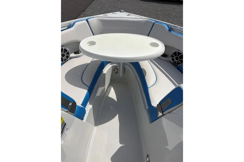 Slide: The Image of 2025 Crownline 220 SS boat interior with white and blue seating and a round table. - 17