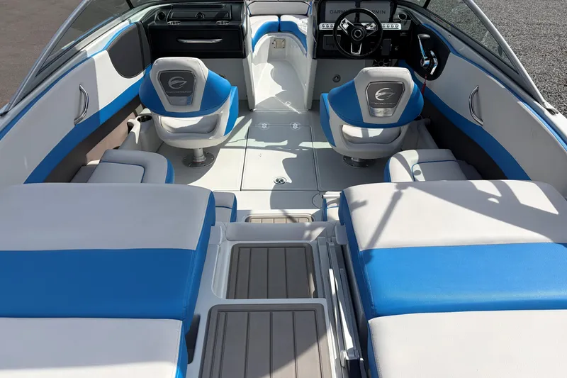 Slide: The Image of 2025 Crownline 220 SS boat interior with blue and white seating, modern dashboard, and steering wheel. - 20