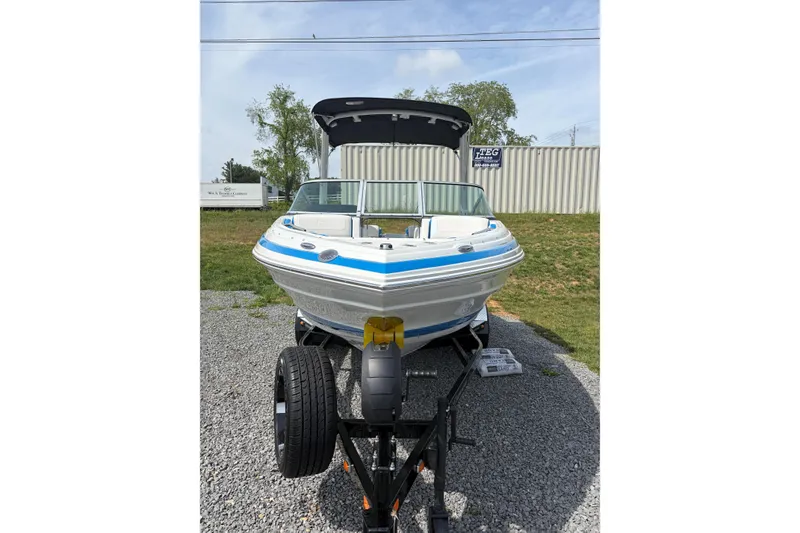 Slide: The Image of 2025 Crownline 220 SS boat on trailer, front view, outdoors. - 5