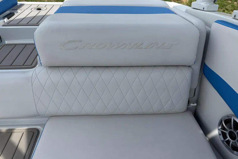Slide: The Image of 2025 Crownline 220 SS boat seat with white and blue upholstery, featuring diamond stitching. - 6