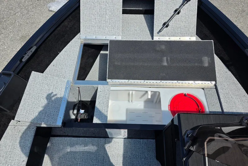 Slide: The Image of 2026 Smoker Craft Pro Angler 165 SC boat interior with storage compartments and fishing gear. - 11