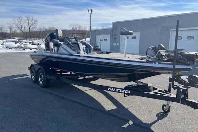 Slide: The Image of 2026 Nitro Z19 XL Pro boat on trailer in parking lot, clear sky background. - 77