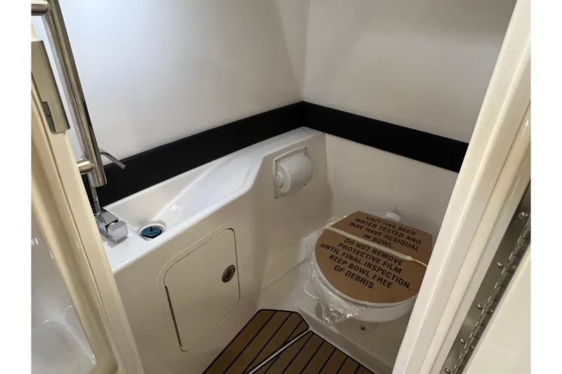 Slide: The Image of Interior of 2025 Sea Ray SLX 260 featuring a toilet. - 13