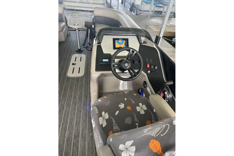 Slide: The Image of 2023 Premier Sunsation boat interior with steering wheel and floral-patterned seat. - 4