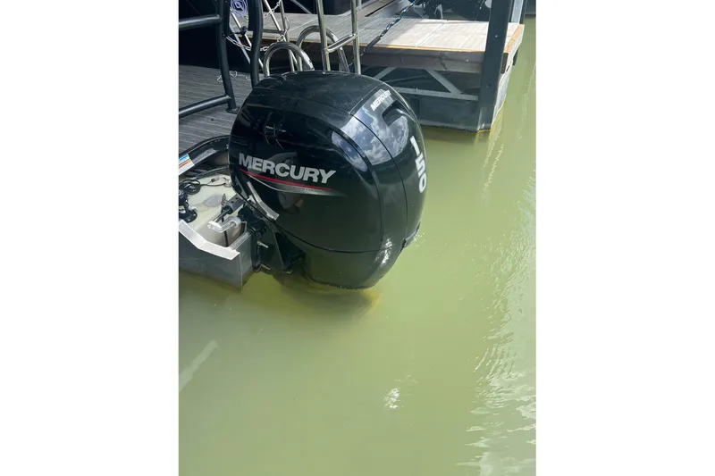 Slide: The Image of 2023 Premier Sunsation boat with Mercury outboard motor in water. - 7