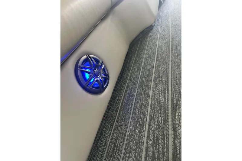 Slide: The Image of 2023 Premier Sunsation boat interior with blue-lit speaker and textured flooring. - 9