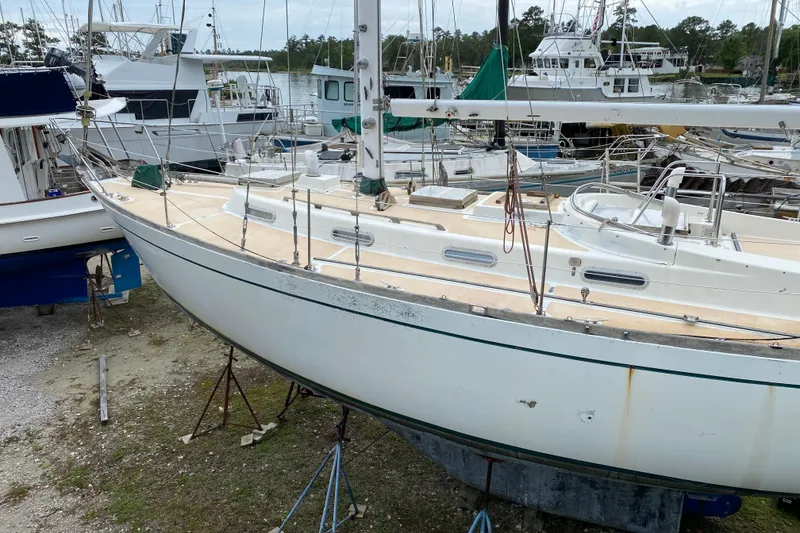 Slide: The Image of Sailboat on stands in marina, Fuji 40 model, 1979, surrounded by other boats. - 11